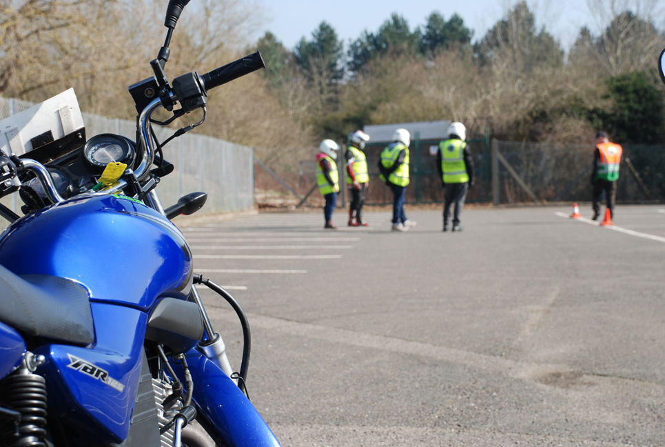 A blue motorcycle parked near a sidewalk